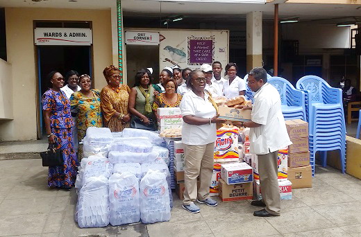 Mrs Grace Asante, President of FAWA (left), presenting the items to Dr Isaac Abban, a paediatrician (right), on behalf of PML Hospital as members of FAWA look on
